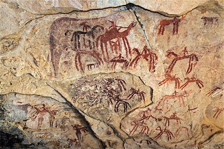 paintings of petroglyphs - Chad, Guili Dweli, Ennedi, Sahara. Paintings of at least two distinct periods decorate the sandstone wall of a cave. Stock Photo - Rights-Managed, Code: 862-06676438