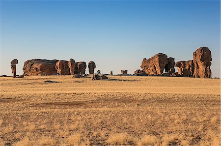 simsearch:862-06676456,k - Chad, Abaike, Ennedi, Sahara. Weathered red sandstone columns in a desert landscape. Stock Photo - Rights-Managed, Code: 862-06676445