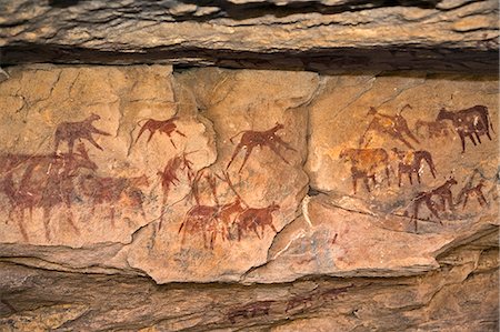 Chad, Taore Koaole, Ennedi, Sahara. Paintings of cattle decorate the sandstone wall of a cave. Stock Photo - Rights-Managed, Code: 862-06676443