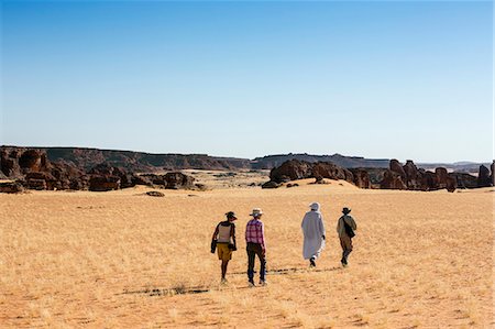simsearch:862-06676456,k - Chad, Abaike, Ennedi, Sahara. Visitors and a guide walking in the Abaike area. Stock Photo - Rights-Managed, Code: 862-06676457