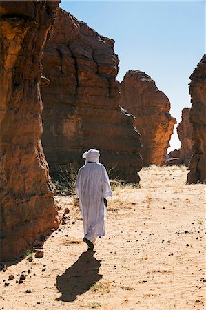 simsearch:862-06676456,k - Chad, Abaike, Ennedi, Sahara. A Toubou guide walking among weathered sandstone landforms in the Abaike area. Stock Photo - Rights-Managed, Code: 862-06676458