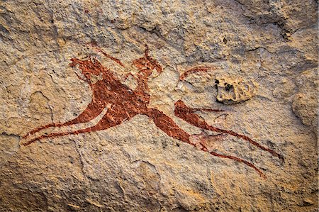 Chad, Terkei East, Ennedi, Sahara. A painting on sandstone of a galloping horse and rider. Stock Photo - Rights-Managed, Code: 862-06676485