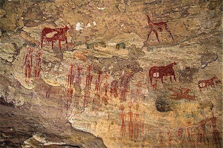 paint man - Chad, Terkei West, Ennedi, Sahara.  An ancient rock art panel of human figures with large decorated hairstyles and domesticated animals. Stock Photo - Rights-Managed, Code: 862-06676529