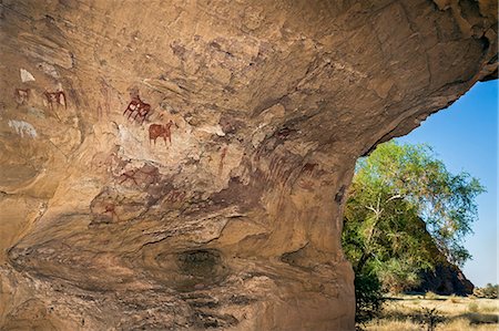 Chad, Terkei West, Ennedi, Sahara.  A large mural of ancient rock art on the side of a shelter. Stock Photo - Rights-Managed, Code: 862-06676534