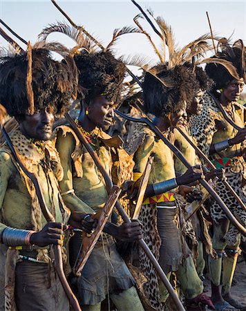 simsearch:862-06676696,k - Dassanech men dressed in ceremonial regalia with long sticks participate in a Dimi dance, Ethiopia Photographie de stock - Rights-Managed, Code: 862-06676741