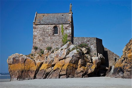 The Romanesque Chapelle Saint Aubert located on a rocky outgrowth at the northwestern end of Mont Saint Michel at low tide, Le Mont Saint Michel, Basse Normandie, France. Stock Photo - Rights-Managed, Code: 862-06676765