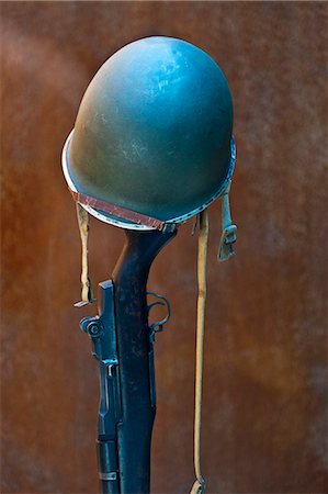 A World War 2 American army helmet atop a vertically placed M1 Garand rifle, USA. Caliber .30-06 at the Normandy American Cemetery and Memorial, Omaha Beach, Colleville sur Mer, Basse Normandie, France. Stock Photo - Rights-Managed, Code: 862-06676787