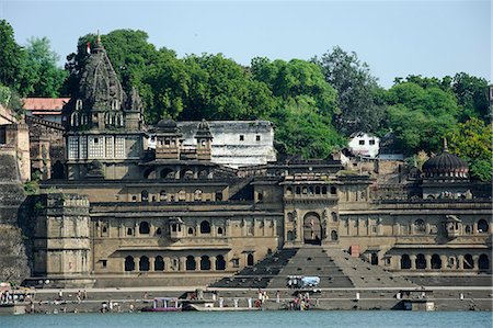 India, Madhya Pradesh, Maheshwar. Below Ahilya Fort and beside the Narmada River's bathing ghats stand elaborate chhatris, or mausouleums, of Ahilya Bai Holkar. Stock Photo - Rights-Managed, Code: 862-06676814