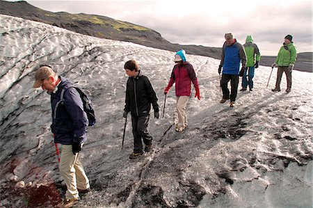 family hike - Tourists on a guided hike on Solheimajokull glacier, a tongue of ice that extends from the Myrdalsjokull glacier on Eyjafjallajokull, Iceland. Stock Photo - Rights-Managed, Code: 862-06676810