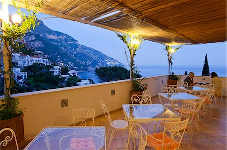 evening on the patio - Italy, Campania, Salerno district, Peninsula of Sorrento, Positano. Hotel Vittoria, terrace Stock Photo - Rights-Managed, Code: 862-06677004