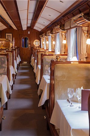 South America, Peru, Cusco, Sacred Valley. The dining car with tables set for dinner on the Orient Express Hiram Bingham train which runs between Cusco and Machu Picchu via Ollantaytambo Stock Photo - Rights-Managed, Code: 862-06677263