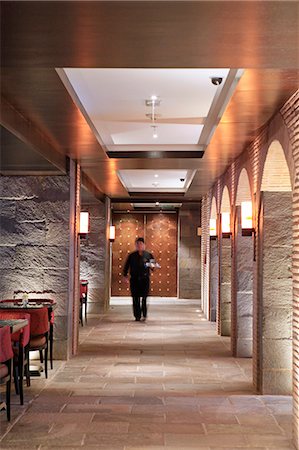 South America, Peru, Cusco, Marriott hotel, a waiter walking along a corridor in the colonial era bar of the hotel which is housed in a former Spanish conven Fotografie stock - Rights-Managed, Codice: 862-06677332