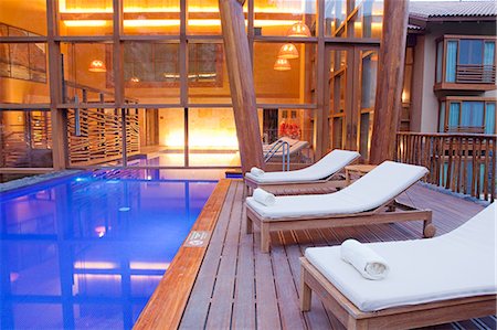 relaxing in lounge chair - South America, Peru, Urubamba, the swimming pool in the spa at the Tambo del Inka resort and spa Stock Photo - Rights-Managed, Code: 862-06677354