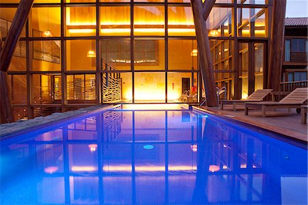 relaxing in lounge chair - South America, Peru, Urubamba, the swimming pool in the spa at the Tambo del Inka resort and spa Stock Photo - Rights-Managed, Code: 862-06677353