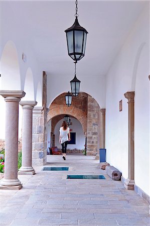 South America, Peru, Cusco, a model walks along a cloister corridor in the Orient Express Palacio Nazarenas hotel, housed in a former Spanish convent, Photographie de stock - Rights-Managed, Code: 862-06677434