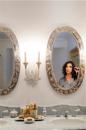 South America, Peru, Cusco, a model puts on make up in the bathroom of the palacio suite in the Orient Express Palacio Nazarenas hotel, housed in a former Spanish convent with interior decoration by Janna Rapaport, Photographie de stock - Rights-Managed, Code: 862-06677437