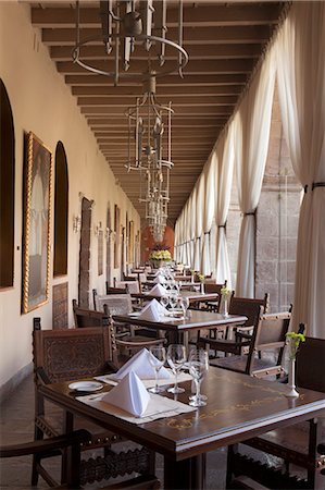 simsearch:862-06675980,k - South America, Peru, Cusco, tables set in a cloister in the restaurant at the Orient Express Monasterio hotel, which is housed in a former Spanish convent, PR, Stock Photo - Rights-Managed, Code: 862-06677445