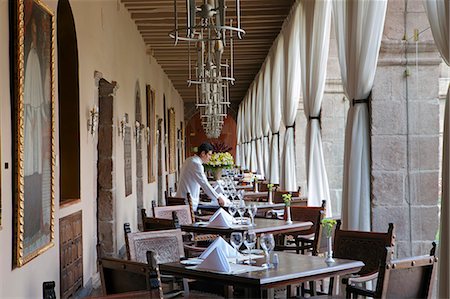 simsearch:862-06675980,k - South America, Peru, Cusco, a waiter setting a table in the restaurant at the Orient Express Monasterio hotel, housed in a former Spanish convent, PR, Stock Photo - Rights-Managed, Code: 862-06677446