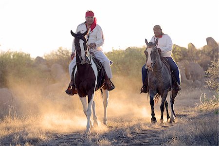 simsearch:862-06677523,k - Two Apache Indians on horseback at the Apache Spririt Ranch near Tombstone, riding through the desert, Arizona, USA Stock Photo - Rights-Managed, Code: 862-06677521