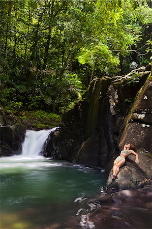 simsearch:862-06825293,k - Dominica, Bense. A young woman lays on the rocks at La Chaudiere Pool. (MR). Foto de stock - Con derechos protegidos, Código: 862-06825223