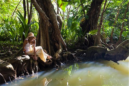 simsearch:862-06825260,k - Dominica, Portsmouth. A young woman sits by the Indian River, one of Dominica's most popular tourist attractions. (MR). Photographie de stock - Rights-Managed, Code: 862-06825258