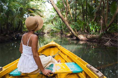 Dominica, Portsmouth. A young woman sits on a boat on the Indian River, one of Dominica's most popular tourist attractions. (MR). Foto de stock - Con derechos protegidos, Código: 862-06825261