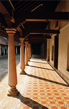 simsearch:862-06825857,k - India, Tamil Nadu, Chettinad region, south of Trichy, Karaikkudi.  Large exterior courtyard at Pothiyan House showing details of the large teak columns and tiled floors. Stock Photo - Rights-Managed, Code: 862-06825793