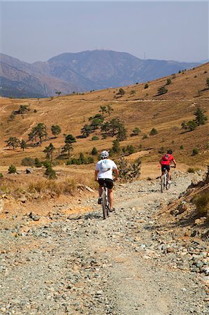 simsearch:862-06825970,k - Northern Italy, Italian Riviera, Liguria, Genova. On mountains overlooking the city of Genova, two men cycling Stock Photo - Rights-Managed, Code: 862-06825942