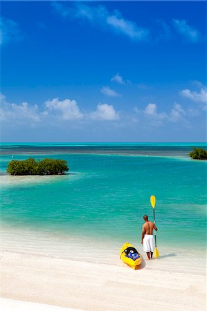 simsearch:862-07495884,k - Central America, Belize, Belize district, Little Frenchman Caye, Royal Palm Island, a young man with a kayak looks out to the Caribbean Sea Stock Photo - Rights-Managed, Code: 862-07495806