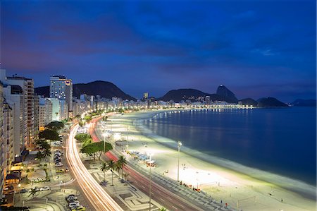 South America, Brazil, Rio de Janeiro, Copacabana. View along Avenida Atlantica (Atlantic Avenue) on Copacabana beach at night with Leme hill and the Sugar Loaf in the distance Photographie de stock - Rights-Managed, Code: 862-07495824