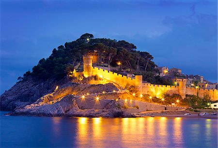 Spain, Catalonia, Costa Brava, Tossa de Mar, Overview of bay and castle at dusk Stock Photo - Rights-Managed, Code: 862-07496275