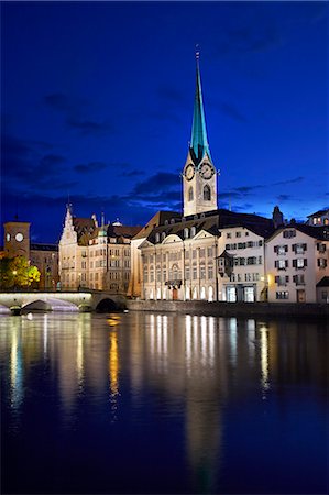 simsearch:841-07082346,k - Europe, Switzerland, Zurich, a night time view of the clocktower of Fraumunster cathedral and the Stadthaus (to the church's left) reflected the Limmat river in the old city centre Fotografie stock - Rights-Managed, Codice: 862-07650665