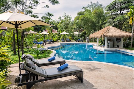 deck chair swimming pool nobody - Cambodia, Siem Reap, Siem Reap Province. The swimming pool at Sojourn Villa, a small boutique hotel on the outskirts of Siem Reap. Stock Photo - Rights-Managed, Code: 862-07689865