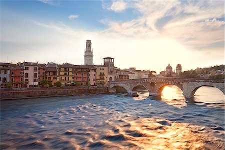 european clock tower on bridge - Italy, Italia Veneto, Verona district. Verona. Italy, Veneto, Verona district, Verona. Ponte Pietra and Church of San Giorgio in Braida in backround. Stock Photo - Rights-Managed, Code: 862-07690223