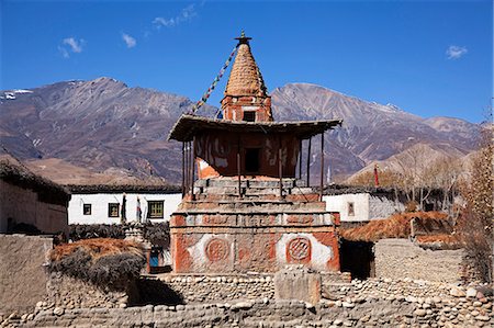 prayer flag - Nepal, Mustang, Tsarang. An old chorten built amongst the houses of Tsarang. Stock Photo - Rights-Managed, Code: 862-07690487