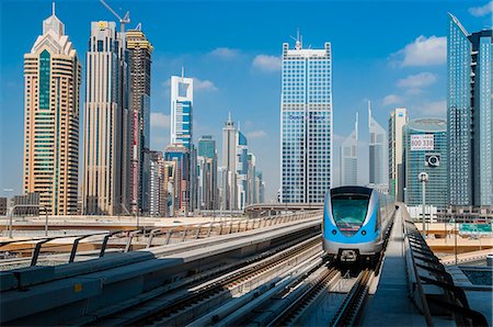 Metro train with city skyline in the background, Dubai, United Arab Emirates Stock Photo - Rights-Managed, Code: 862-07690941