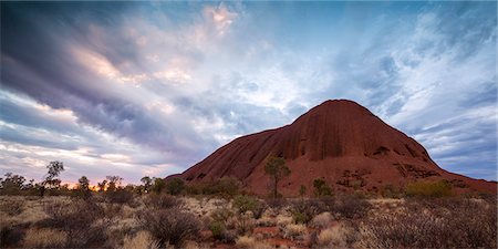 simsearch:862-03736258,k - Uluru Kata Tjuta national park, Northern Territory, Australia. Uluru at sunset, under a stormy sky Stock Photo - Rights-Managed, Code: 862-07909376