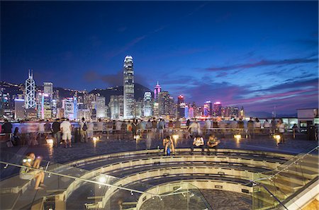 Tourists looking at Hong Kong Island skyline from Tsim Sha Tsui at dusk, Hong Kong Stock Photo - Rights-Managed, Code: 862-07909505