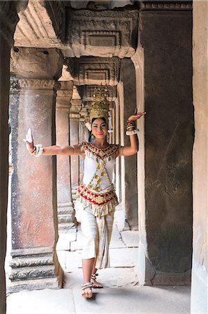 southeast asia traditional clothing - Cambodia, Siem Reap, Angkor Wat complex. Khmer Apsara dancer performing inside Ta Prohm temple (MR) Stock Photo - Rights-Managed, Code: 862-07909514