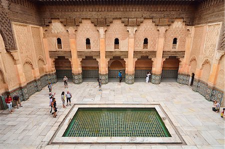 Courtyard of the beautifully restored Ben Youssef Medersa. It is the largest theological school in Morocco. Built in 1565 it once housed 900 students and teachers in the rooms above the courtyard. Marrakech, Morocco Photographie de stock - Rights-Managed, Code: 862-07910300