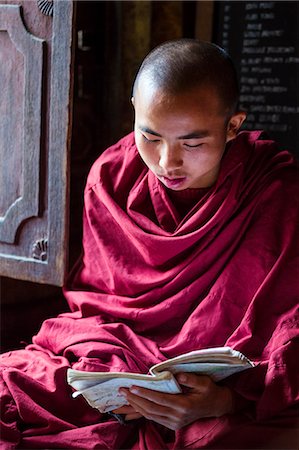 studying young asian boy - Myanmar, Shan state,  Nyaungshwe Township. Young novice monk, Shwe Yan Pyay Monastery (MR) Stock Photo - Rights-Managed, Code: 862-07910340