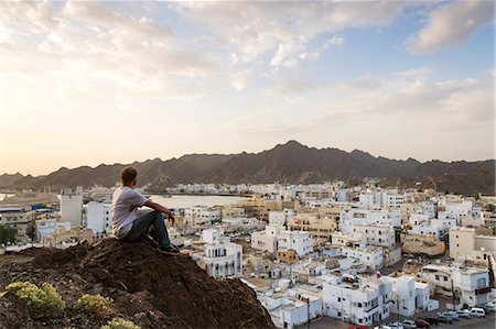 Oman, Muscat. Tourist looking at Mutrah old town, elevated view, at sunrise (MR) Stock Photo - Rights-Managed, Code: 862-07910373