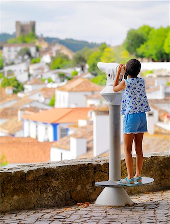 simsearch:862-07910527,k - Portugal, Estramadura,Obidos, overview of 12th century town at dusk, girl looking through telescope (MR) Stock Photo - Rights-Managed, Code: 862-07910505