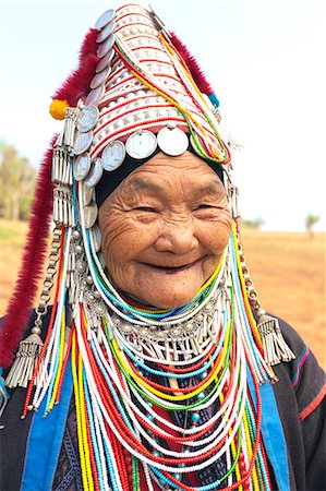 Thailand, Chiang Rai. Portrait of woman of Ahka tribe wearing traditional dress and headgear with silver coins (MR) Foto de stock - Con derechos protegidos, Código: 862-07910818