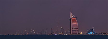 The three iconic landmarks of Subai, The 7 star Burj al Arab Hotel, The 5 star Jumeriah Beach Hotel and the Burj Khalifa containg the 5 star Armani Hotel, viewed from the Palm Jumeriah at twilight, Dubai, The United Emirates. Stock Photo - Rights-Managed, Code: 862-07910846