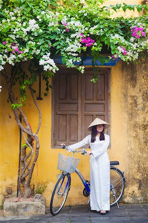 southeast asian ethnicity (female) - Woman wearing Ao Dai dress with bicycle, Hoi An (UNESCO World Heritage Site), Quang Ham, Vietnam (MR) Stock Photo - Rights-Managed, Code: 862-07911078