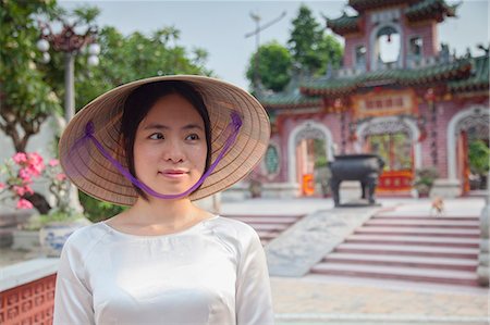 Woman wearing Ao Dai dress at Phouc Kien Assembly Hall, Hoi An (UNESCO World Heritage Site), Quang Ham, Vietnam (MR) Stock Photo - Rights-Managed, Code: 862-07911095