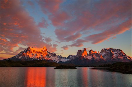 simsearch:862-08698774,k - Chile, Torres del Paine, Magallanes Province. Sunrise over Torres del Paine with Lake Pehoe in the foreground. One of the principal attractions of the National Park is the magnificent Paine massif. Stock Photo - Rights-Managed, Code: 862-08090052