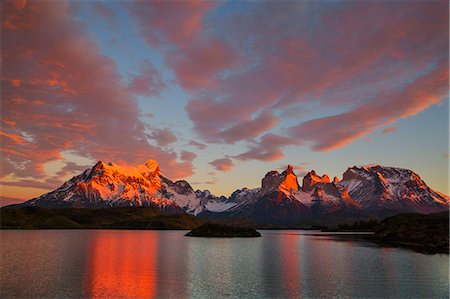 simsearch:862-08090052,k - Chile, Torres del Paine, Magallanes Province. Sunrise over Torres del Paine with Lake Pehoe in the foreground. One of the principal attractions of the National Park is the magnificent Paine massif. Stock Photo - Rights-Managed, Code: 862-08090052