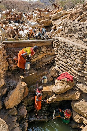 simsearch:862-08090671,k - Kenya, Marsabit County, Lechet. Samburu women and girls water their family' s goats at the deep wells at Lechet in the foothills of the Ndoto Mountains. Stock Photo - Rights-Managed, Code: 862-08090672